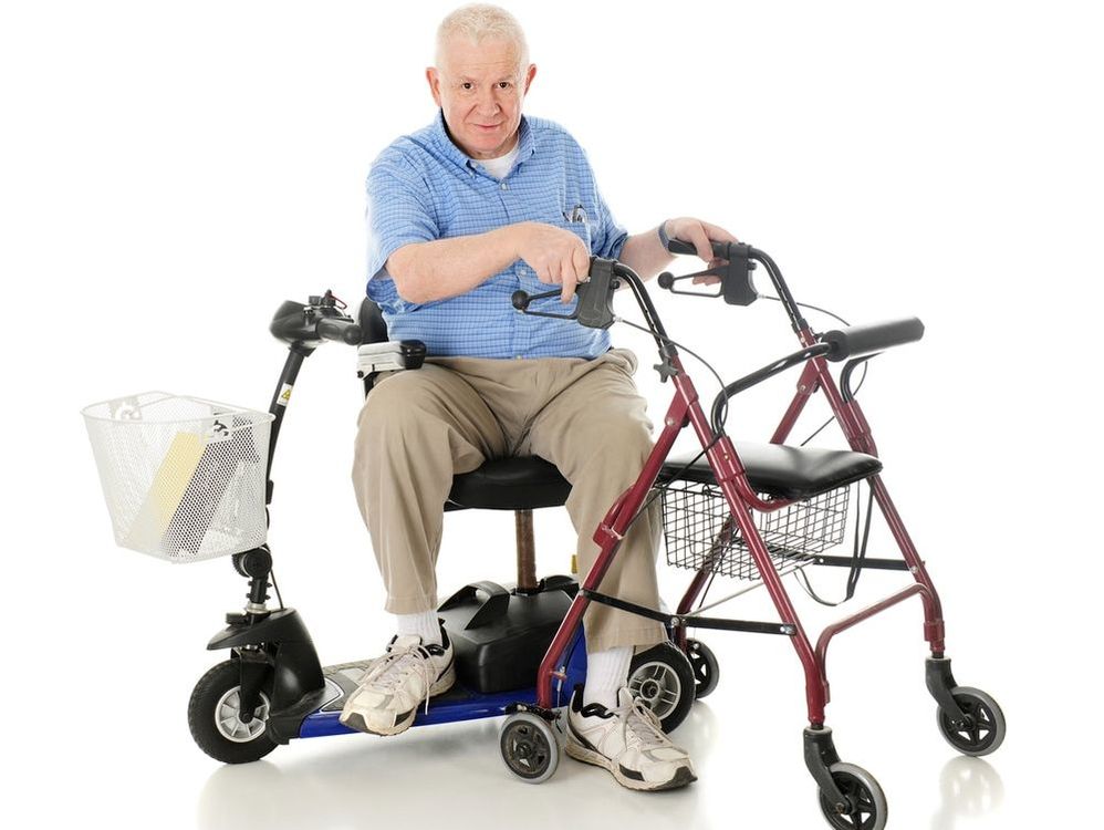Man sitting on mobility scooter with a mobility walking aid